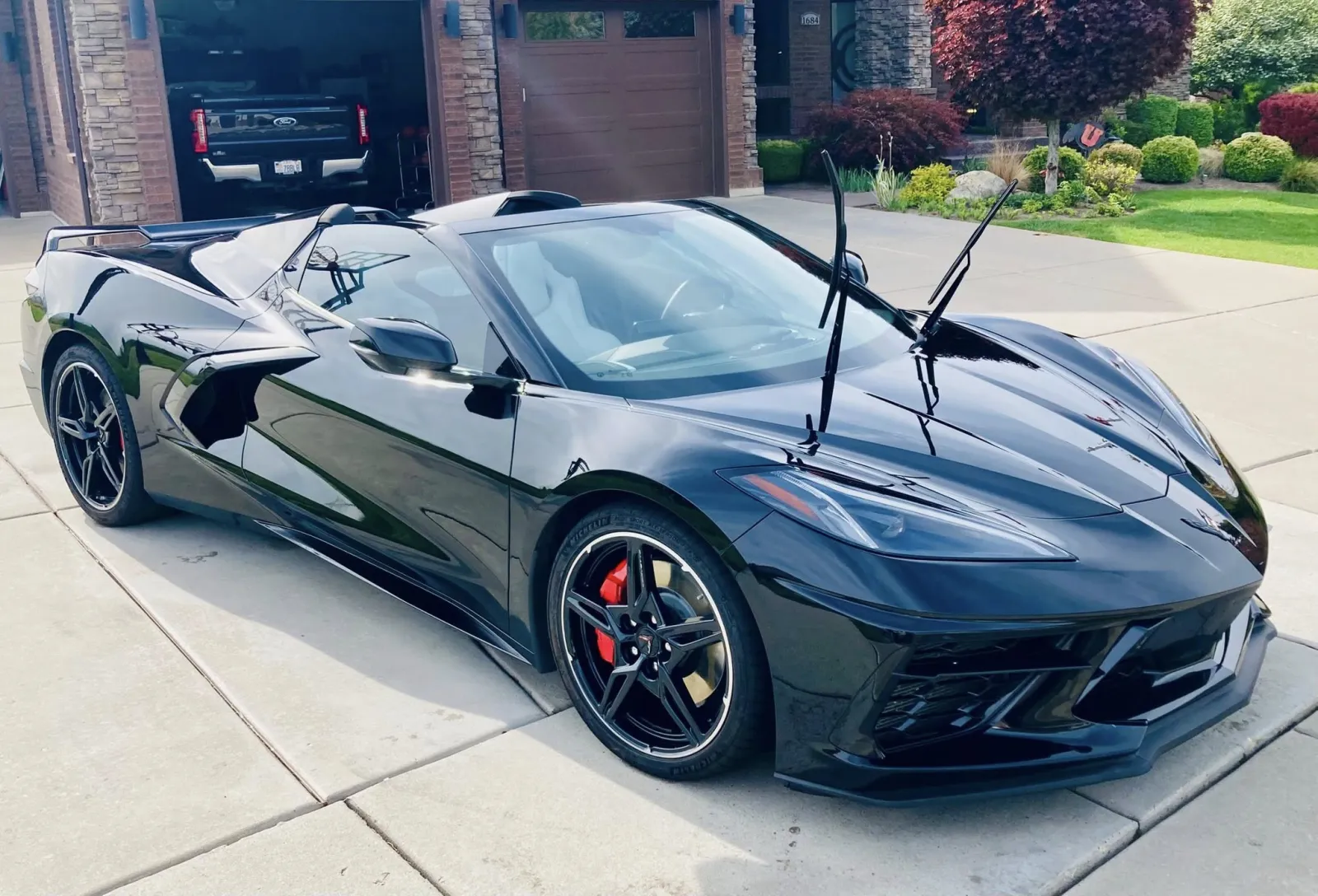 Water beads on a freshly ceramic-coated black car hood — exterior revival detail by Executive Detail Utah