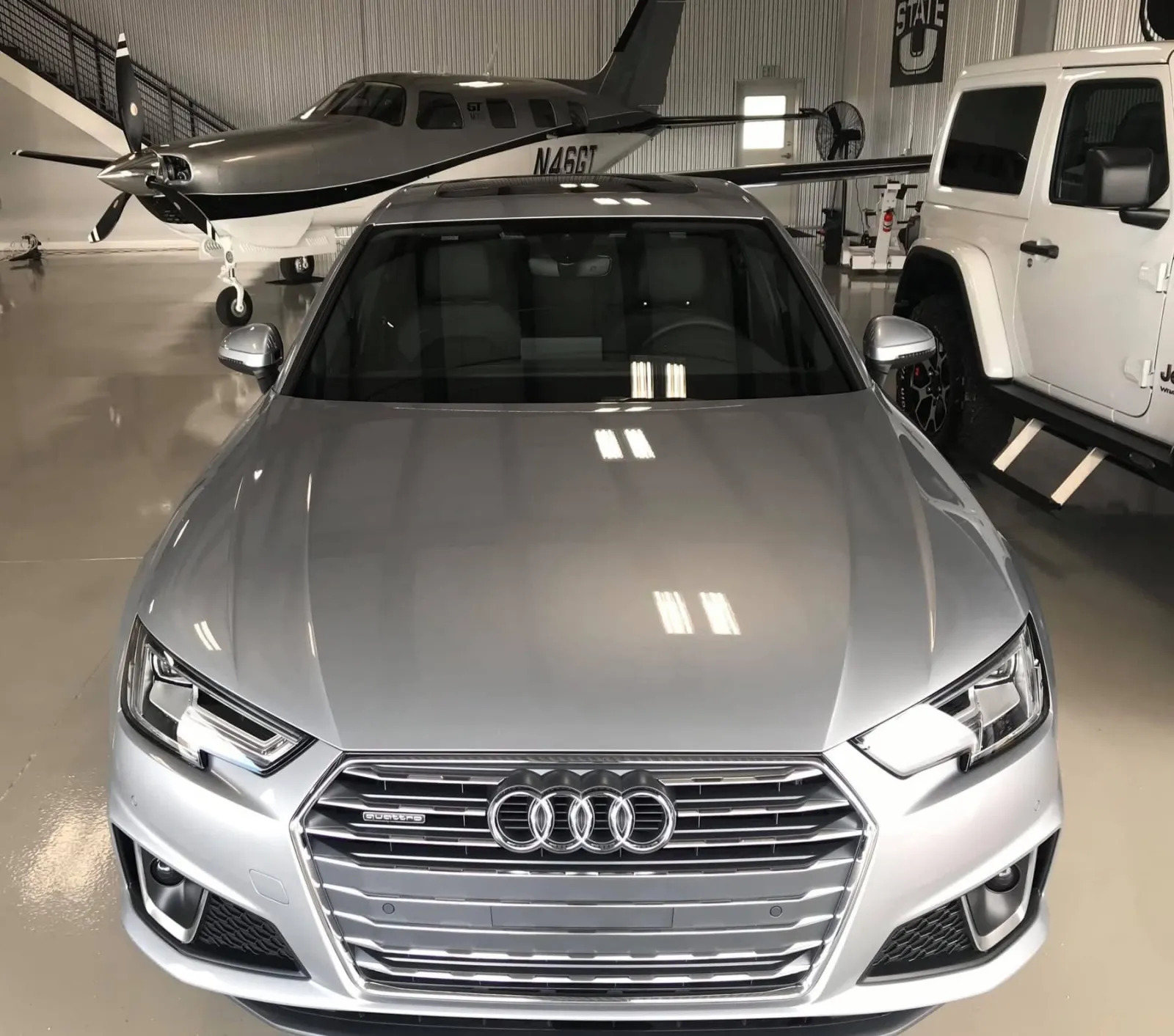 Silver Audi Quattro freshly detailed in a private hangar — Executive Package by Executive Detail Utah