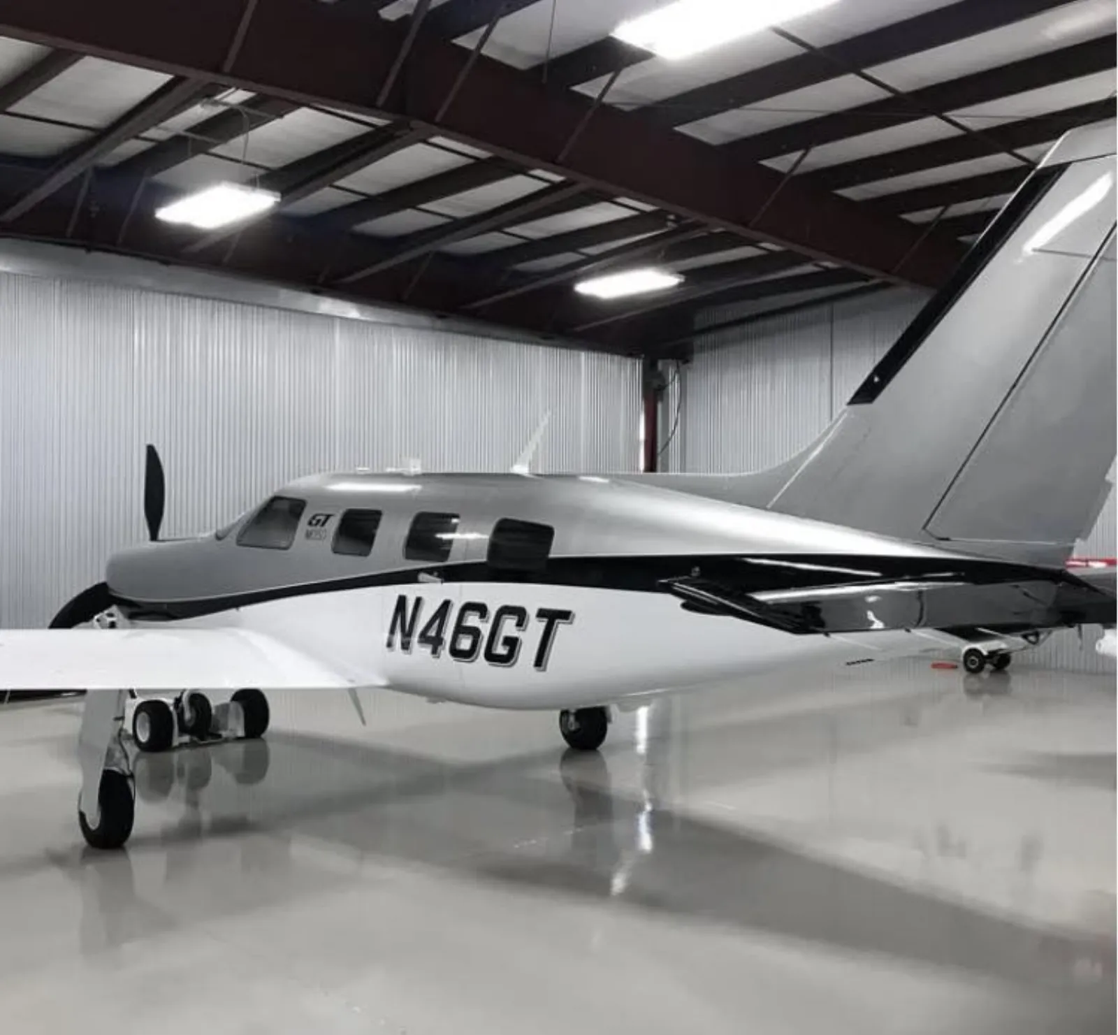 Silver Piper M350 N46GT in hangar