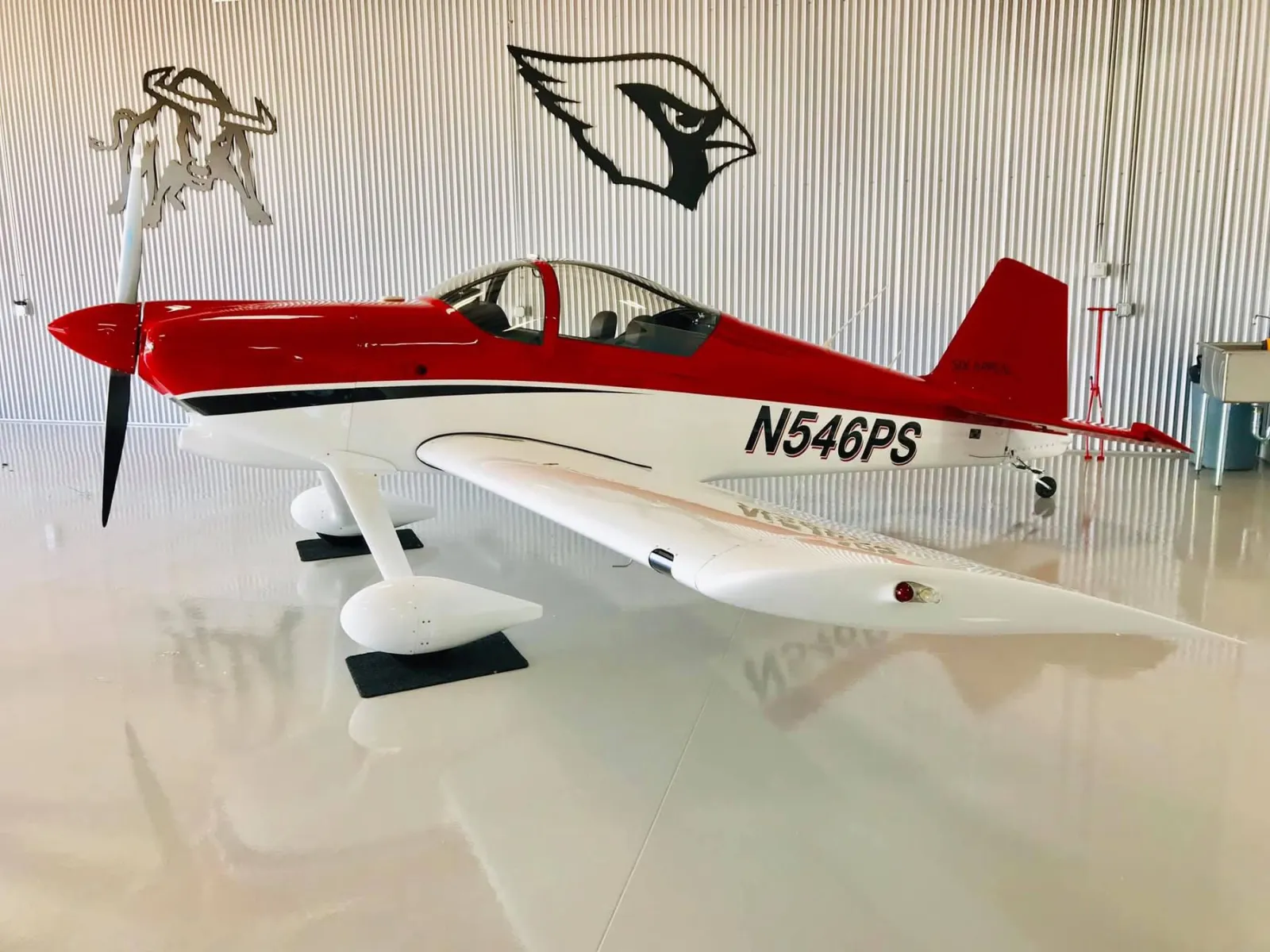 Red and white aircraft in hangar